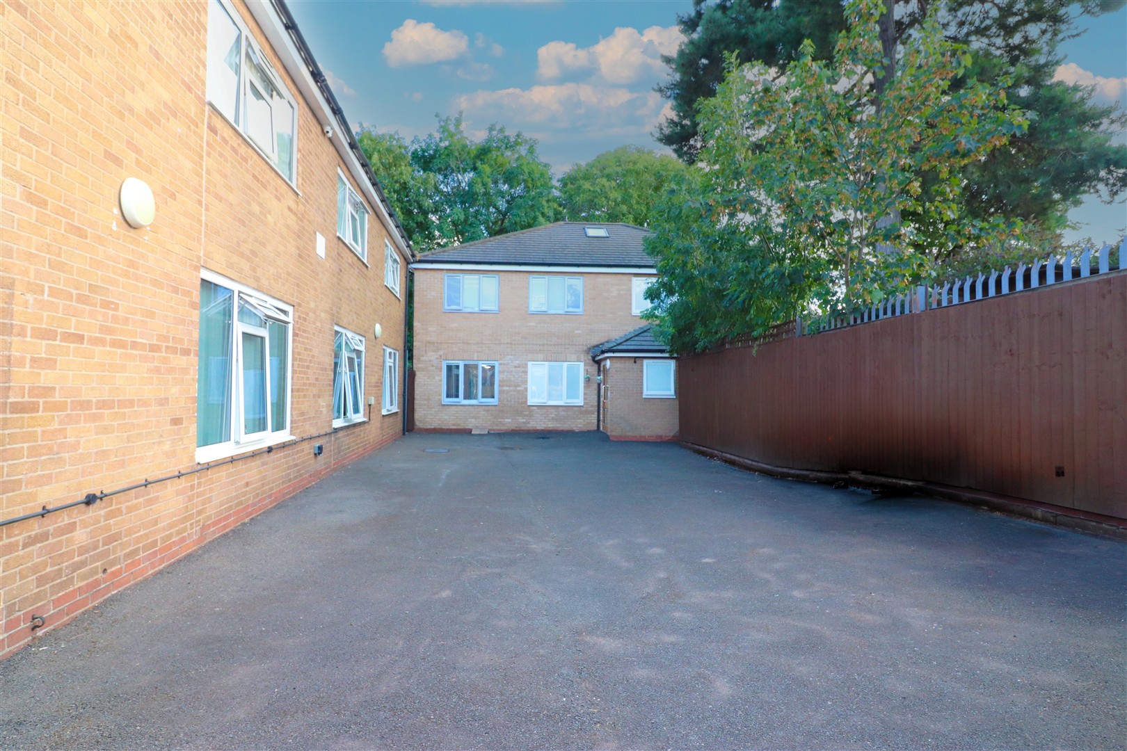 Queens Lodge across the yard from Queens Park